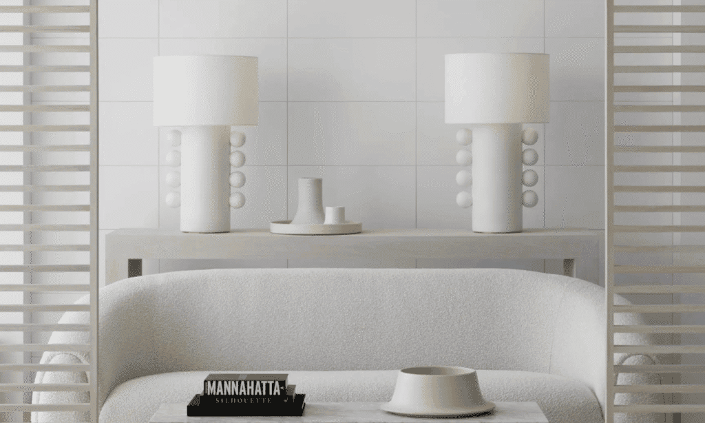 Organic sculptural table lamp displayed on a modern console table with contemporary artwork. | Visual Comfort & Co. | LXURI 